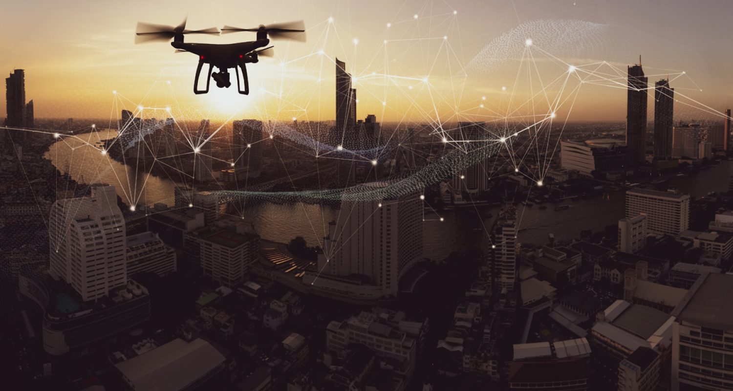 drone-quad-copter-with-high-resolution-digital-camera-on-the-sky-mountain-and-city-background Drone quad copter with high resolution digital camera on the sky mountain and city background.