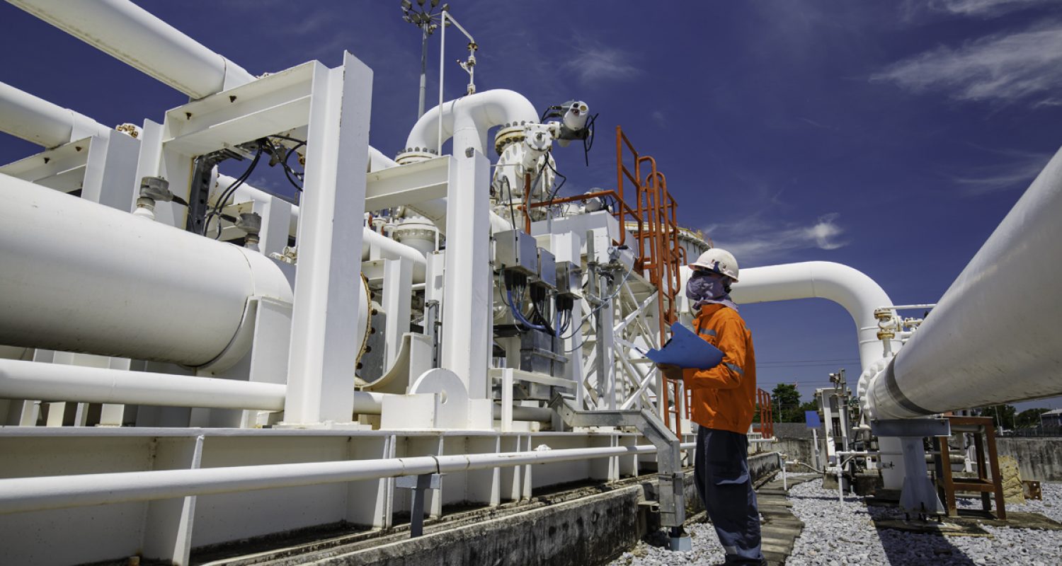 Male worker inspection at steel long pipes and pipe elbow in sta Male worker inspection at steel long pipes and pipe elbow in station oil factory during refinery valve of visual check record pipeline oil and gas industry