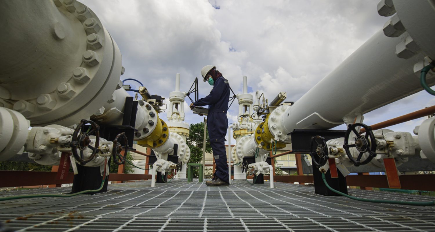 Male worker inspection at steel long pipes and pipe elbow in sta Male worker inspection at steel long pipes and pipe elbow in station oil factory during refinery valve of visual check record pipeline oil and gas industry.