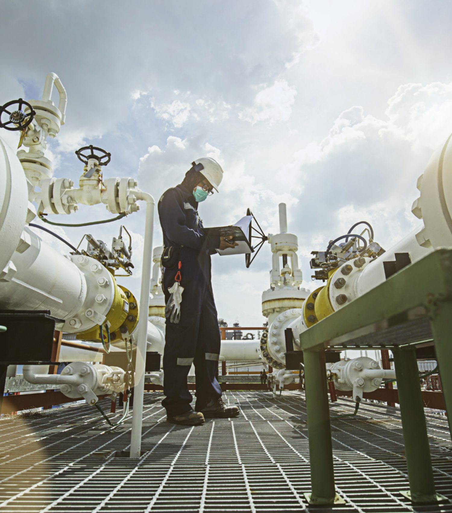 Male worker inspection at steel long pipes and pipe elbow in sta Male worker inspection at steel long pipes and pipe elbow in station oil factory during refinery valve of visual check record pipeline oil and gas industry.